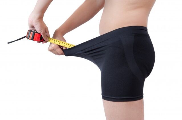 man measuring penis length